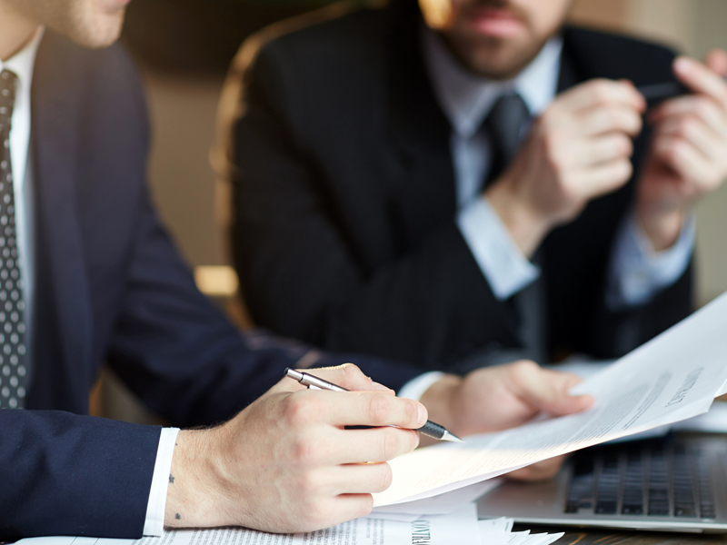 Analista financeiro estudando gráficos de fluxo de caixa e projeções empresariais